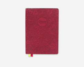 Red planner with embossed fire design on a white background