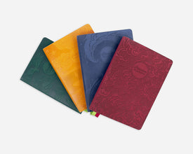 Four colorful embossed planners on a white background