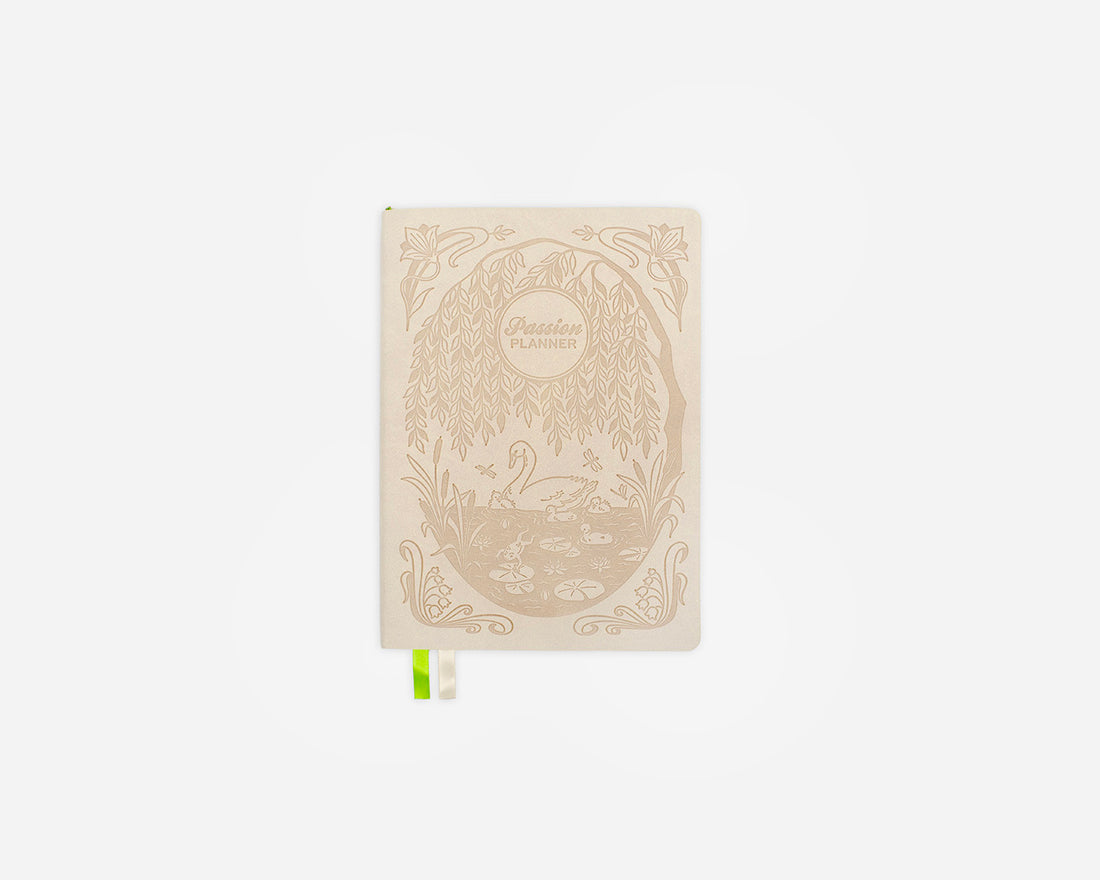 Decorative cream colored weekly planner with a swan design on a white background