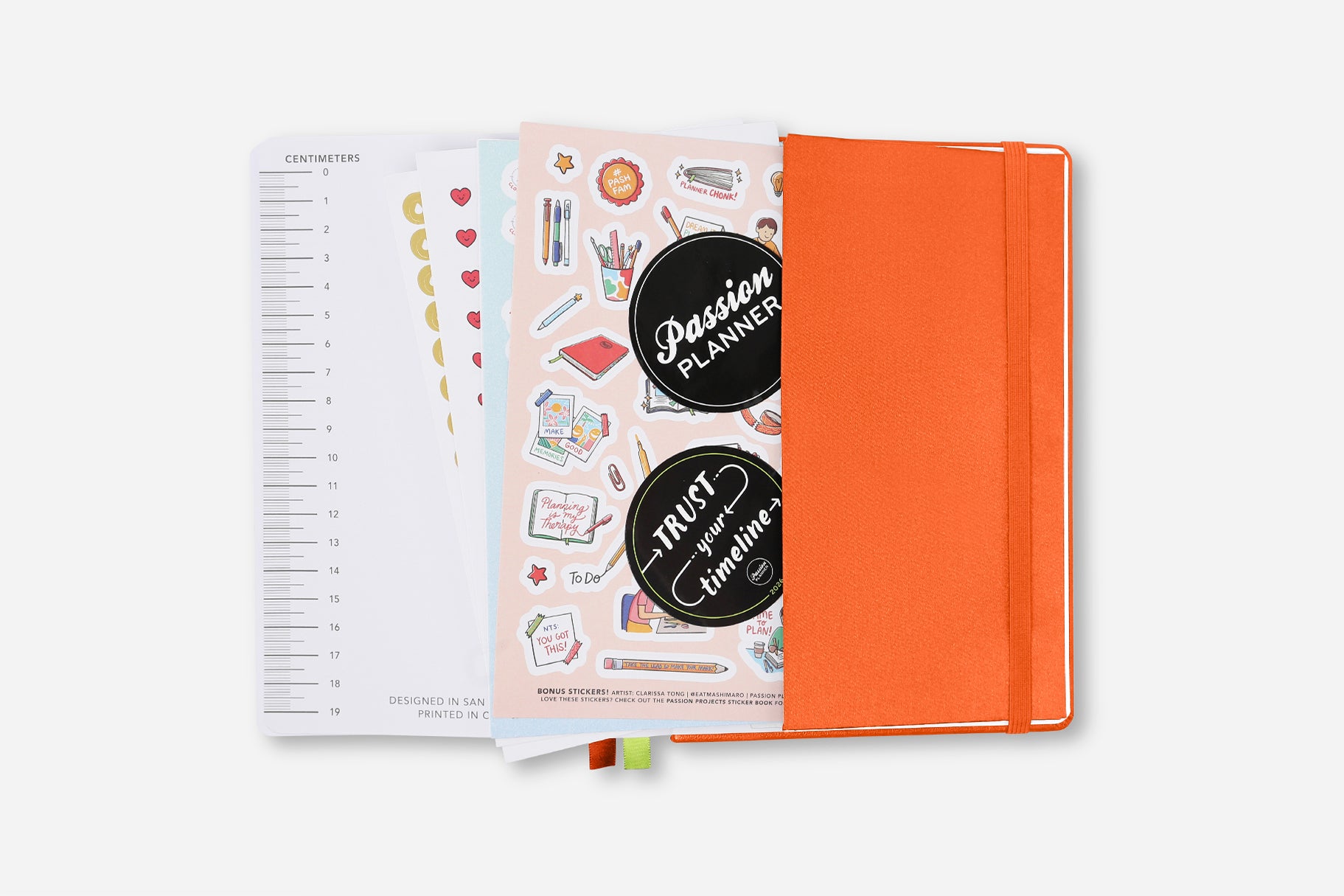 Orange planner with stickers on a white background