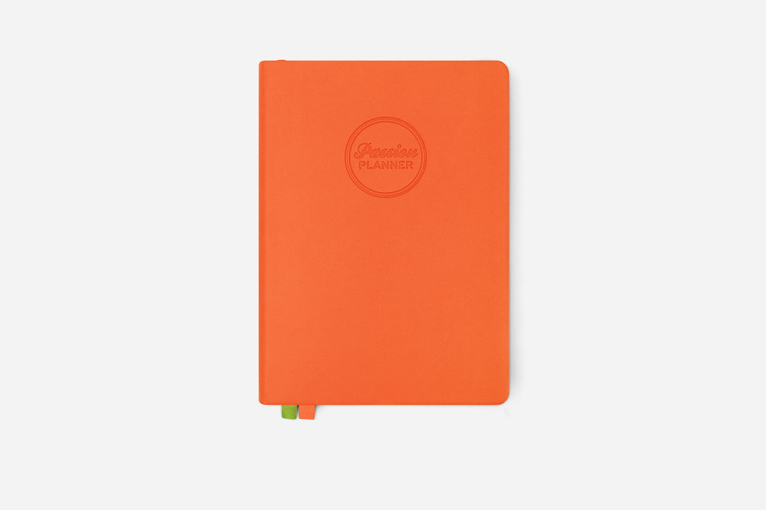 Orange planner with a brand logo on a white background