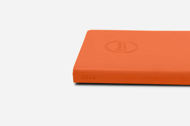 Orange weekly planner with '2026' printed on a white background