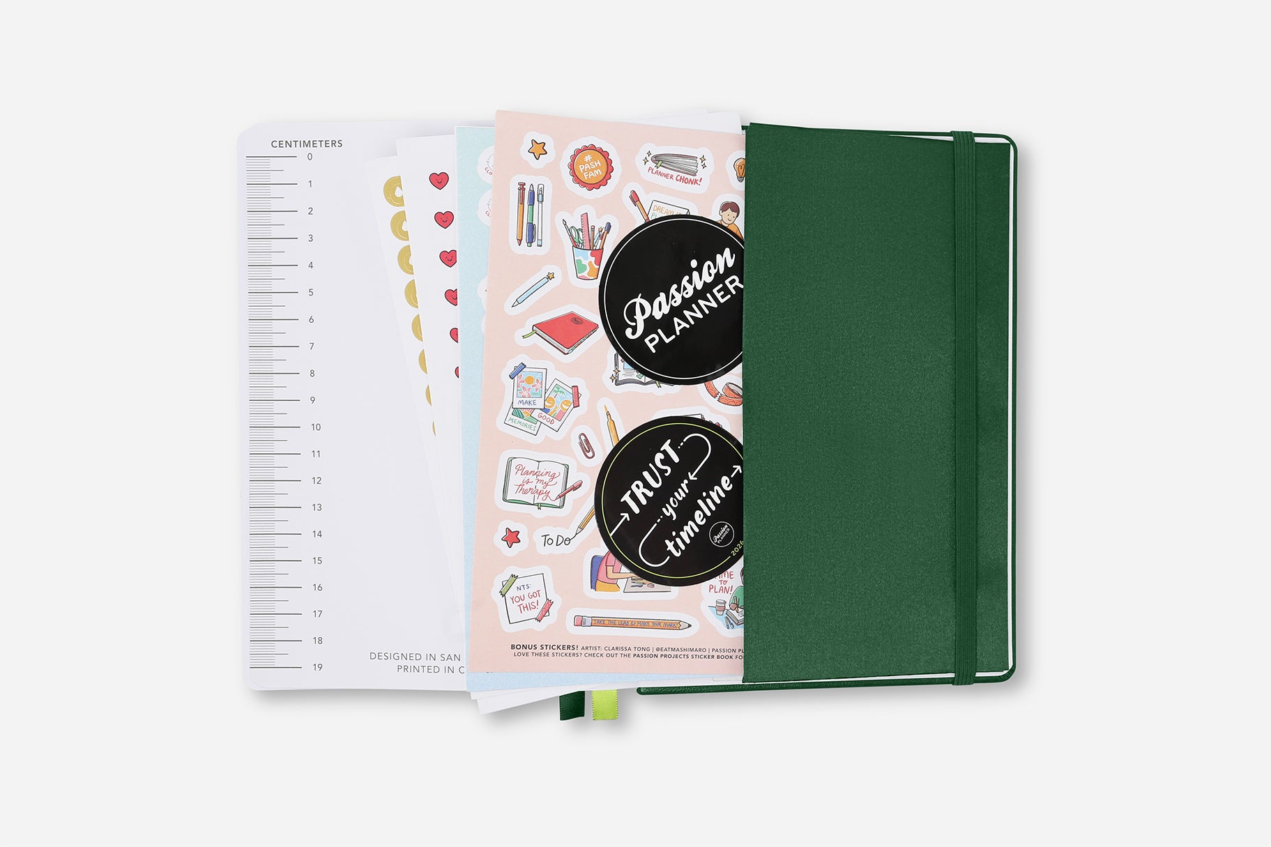 Green planner with stickers on a white background