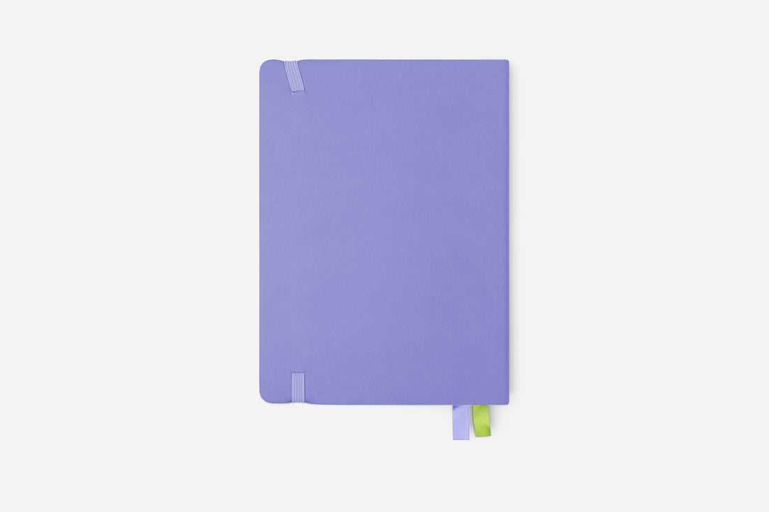 Purple planner with a green bookmark on a white background