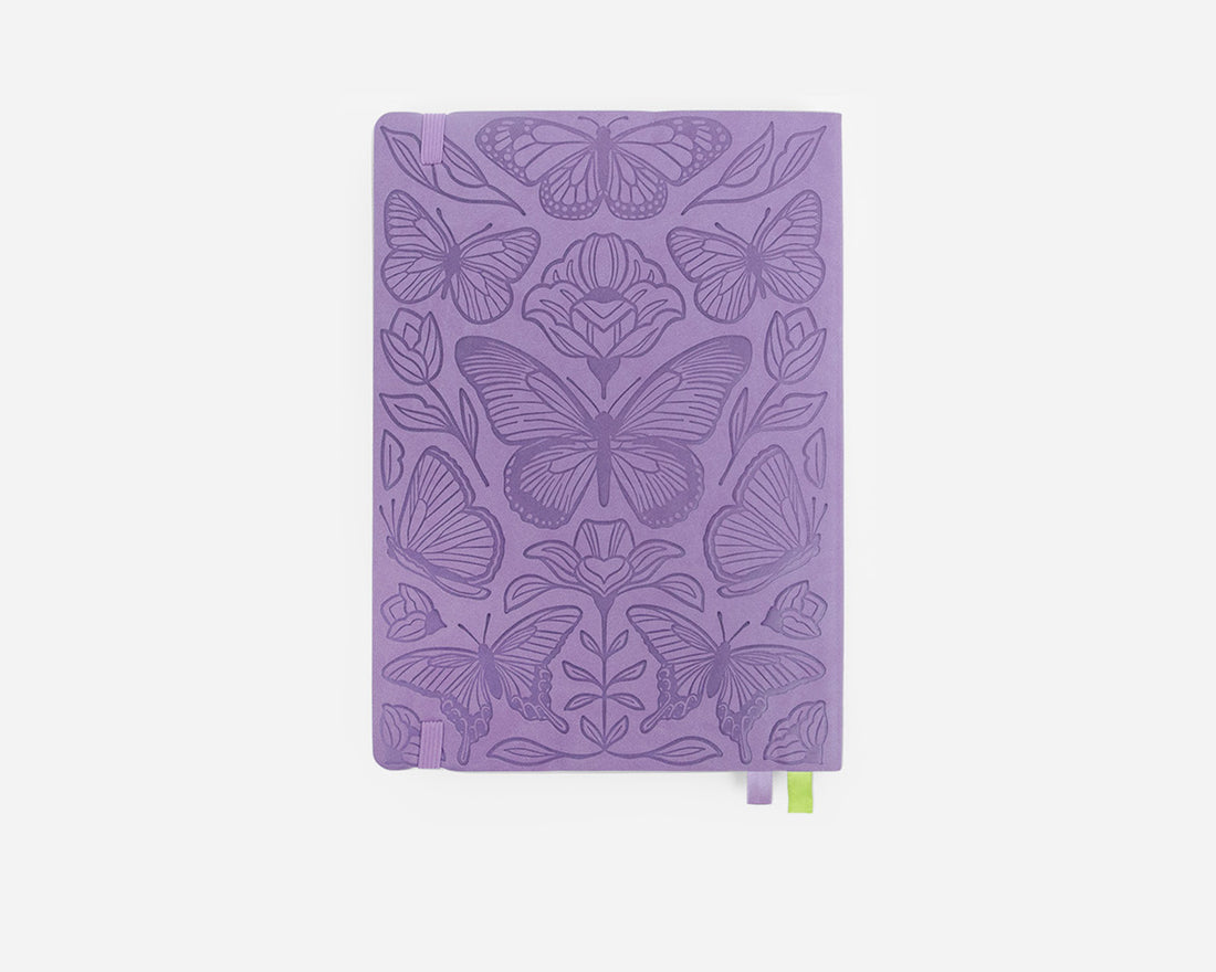 Purple notebook with butterfly design on a white background
