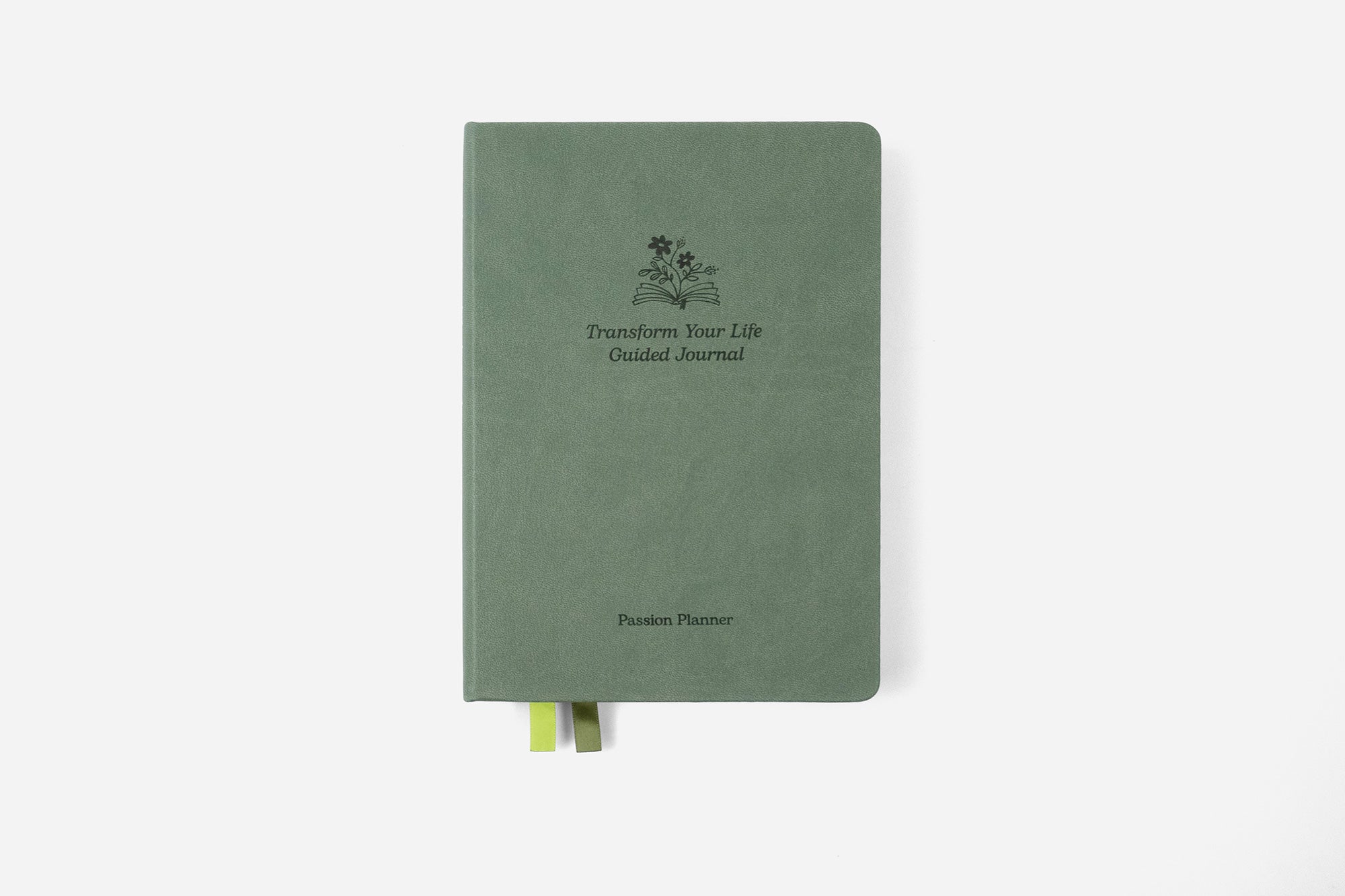 Green 'transform your life' guided journal on a white background