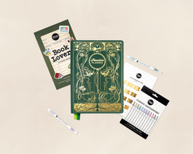 A flat-lay arrangement of themed stationery and art supplies on a light beige background, including a green and gold decorative 2027 planner, a Book Lovers Sticker Book, monthly tabs, and a set of colorful highlighter pens.