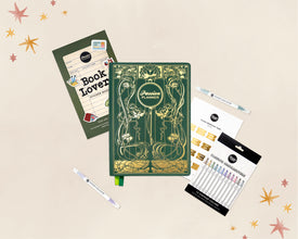 A flat-lay product arrangement on a light beige background with decorative star confetti. The main item is a green 2027 journal with ornate gold Art Nouveau-style illustrations and the title 'Passion Planner' on the cover.