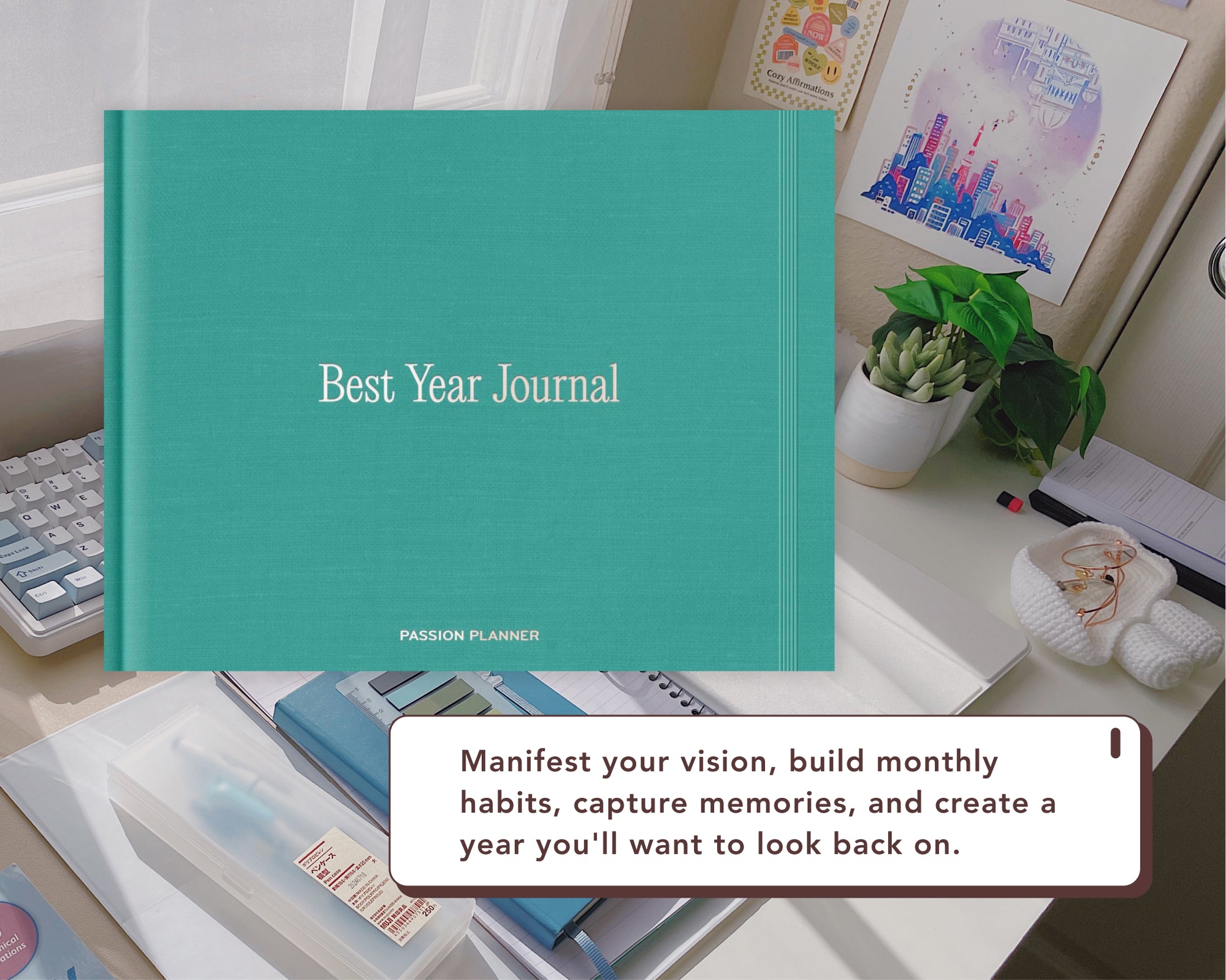 A teal Best Year Journal by Passion Planner is displayed on a desk with a white text overlay that reads 'Manifest your vision, build monthly habits, capture memories, and create a year you'll want to look back on.'.