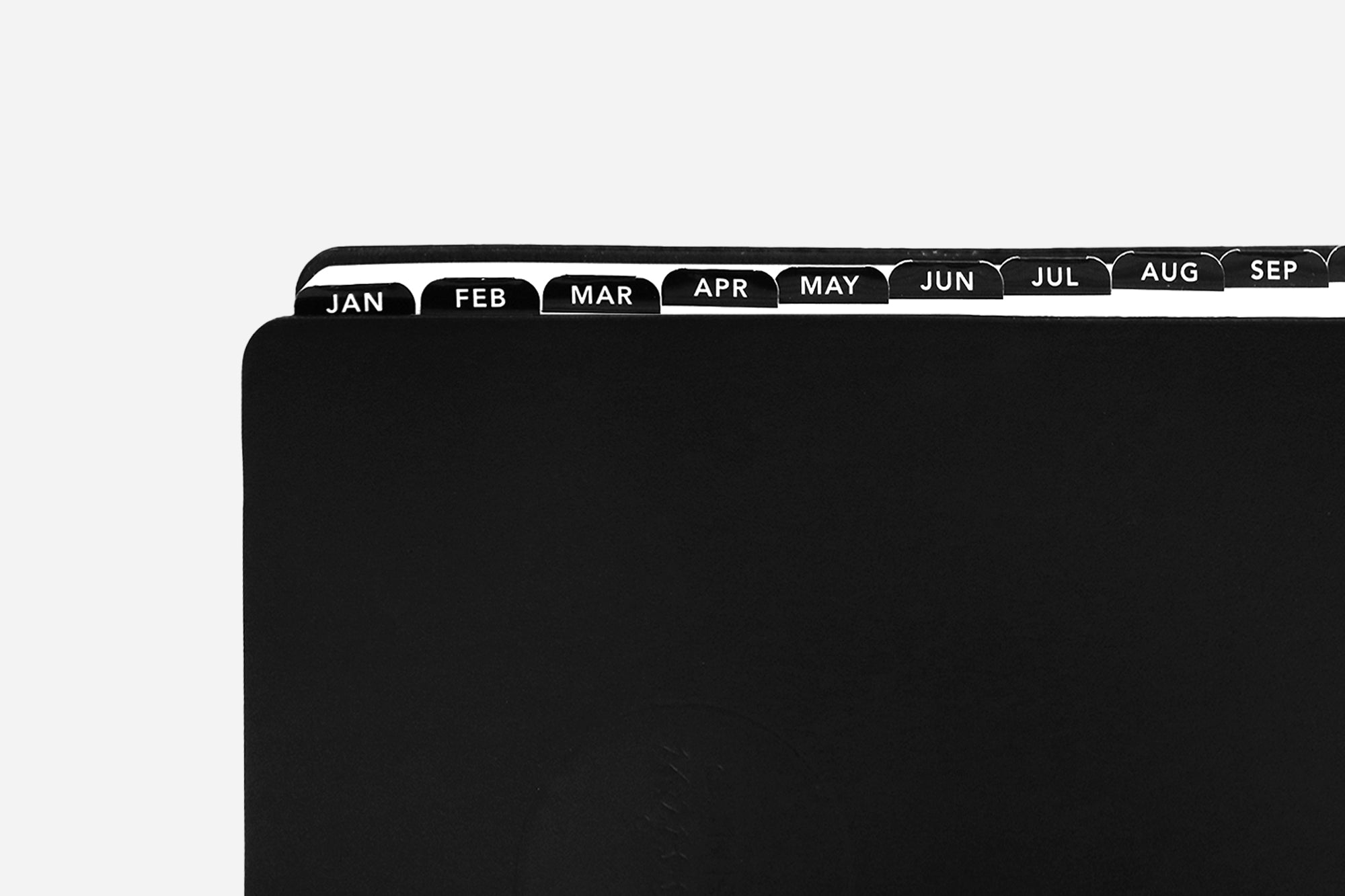 Black planner with month labels on a white background