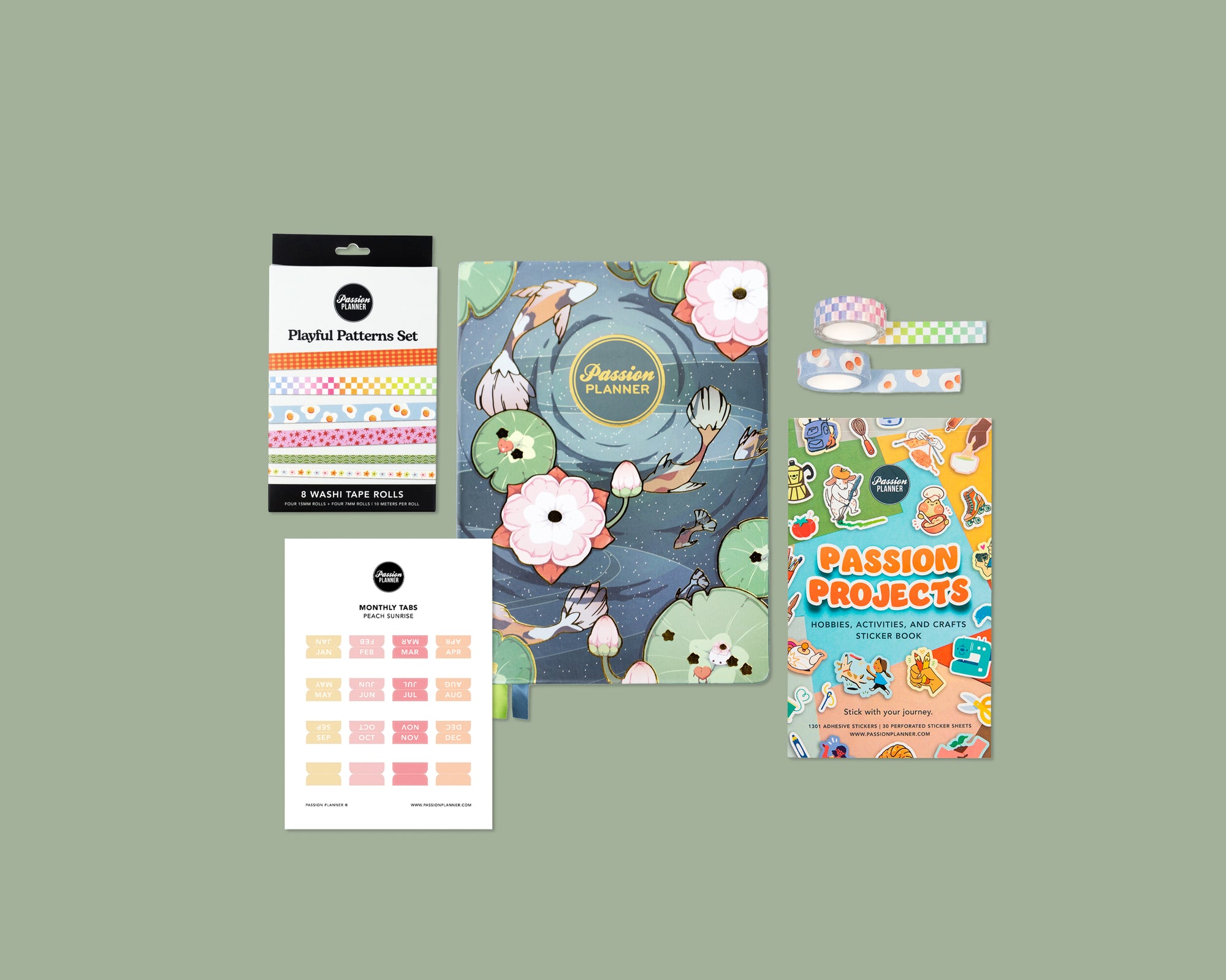 Collection of planner accessories including a mid-year planner, washi tape rolls, and stickers on a green background