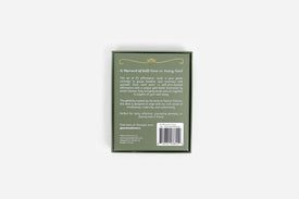 Back of affirmation card packaging with text and barcode on a light gray background