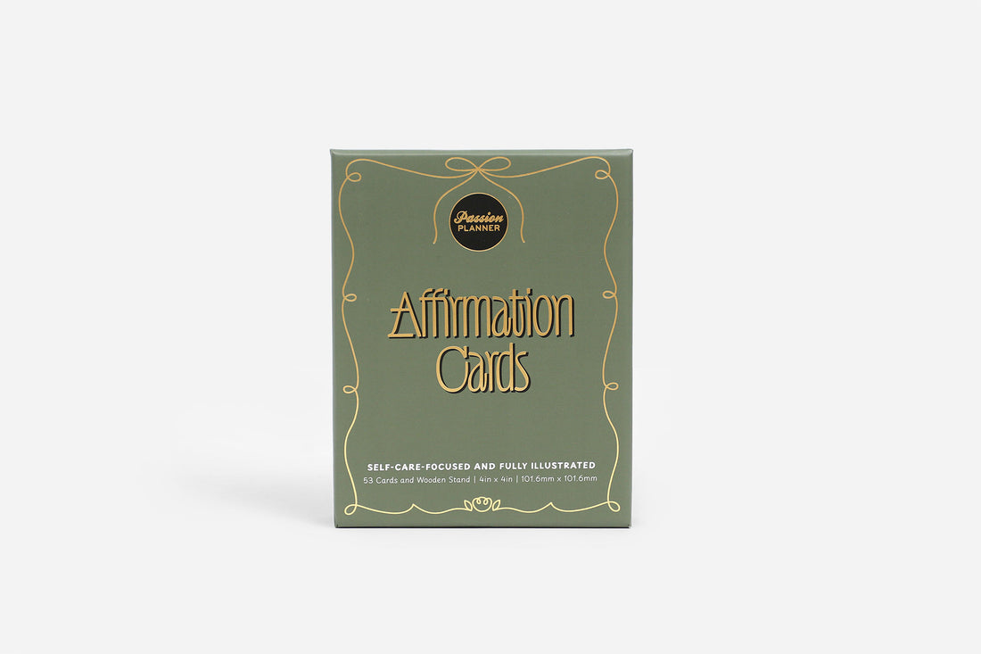 Box of affirmation cards with decorative design on a white background