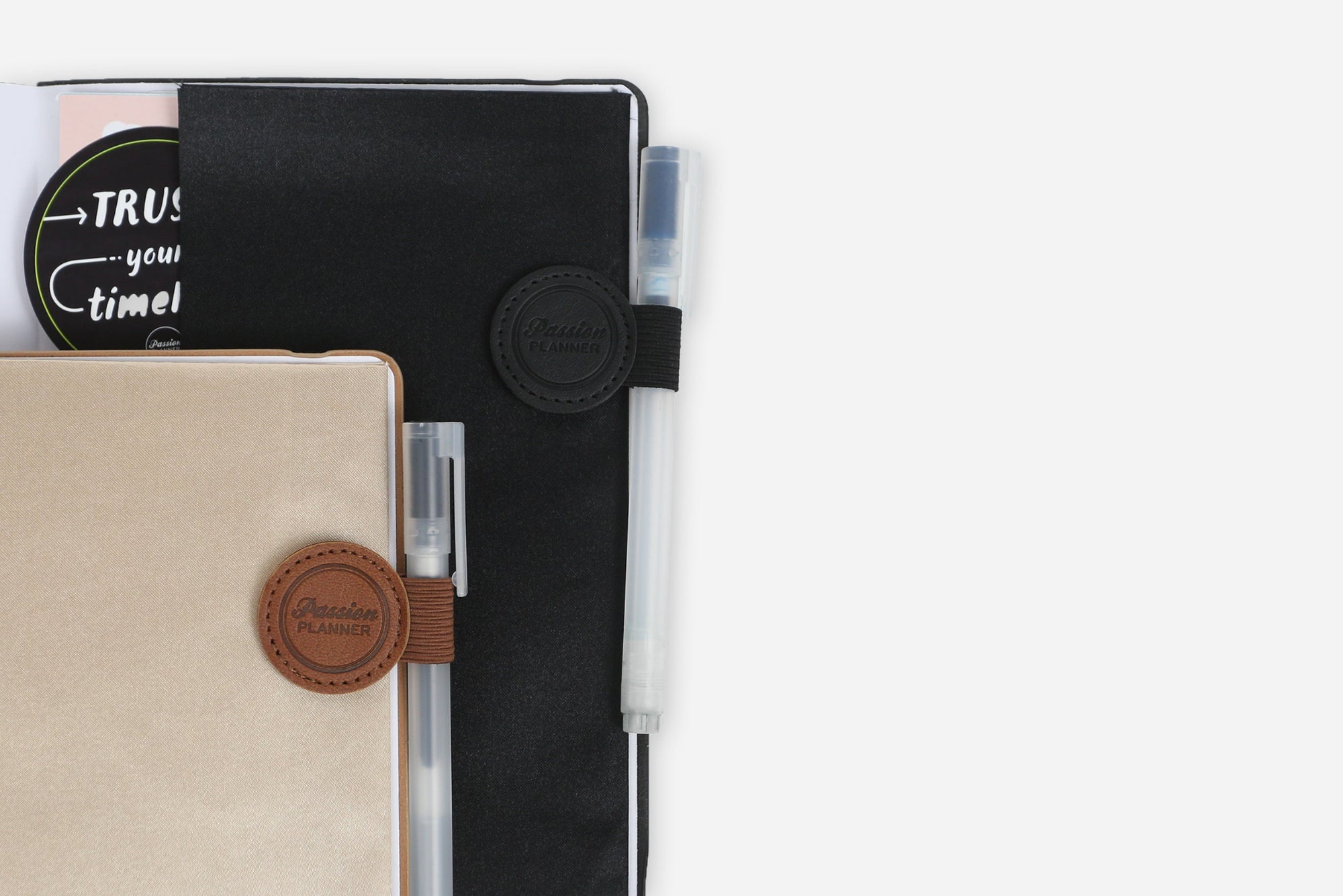 Two planners with pen holders on a white background