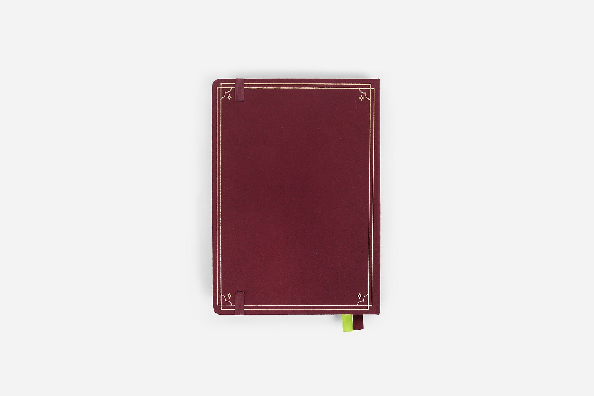 Maroon reading journal with decorative gold edges on a white background
