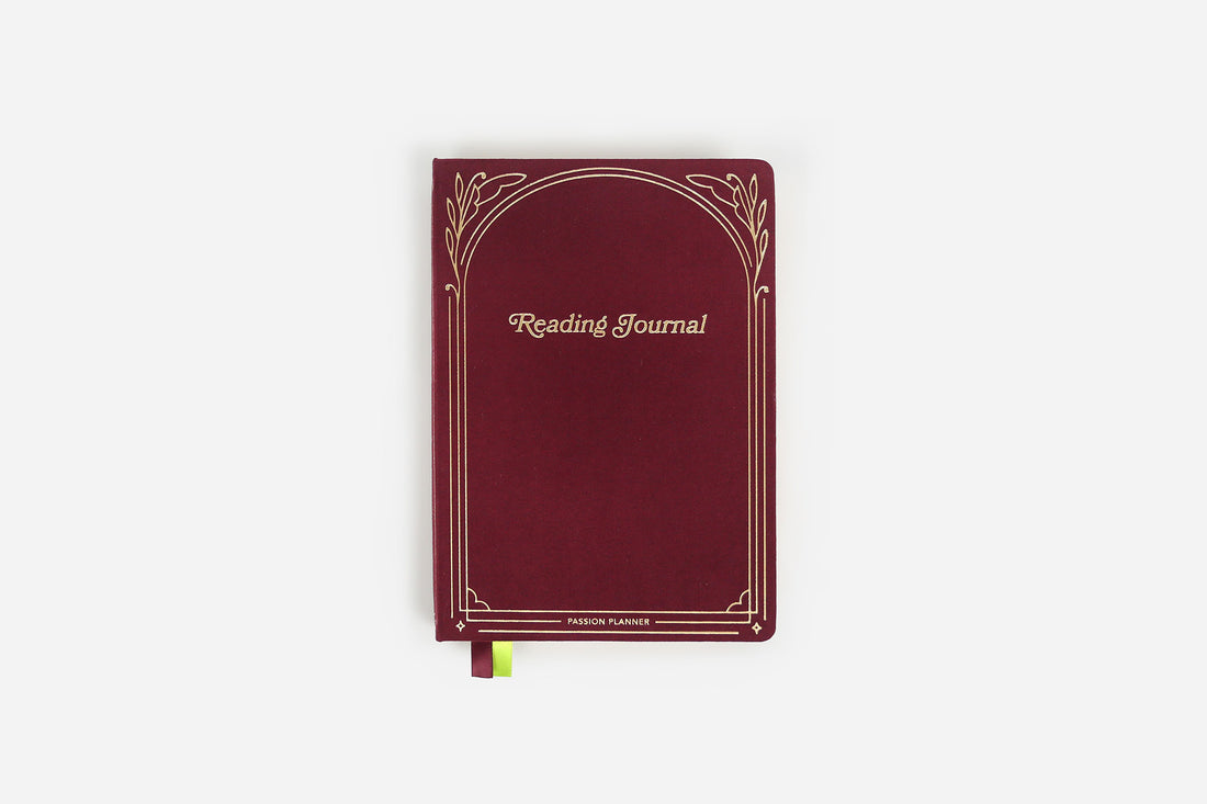 Maroon reading journal with decorative gold foil elements on a white background