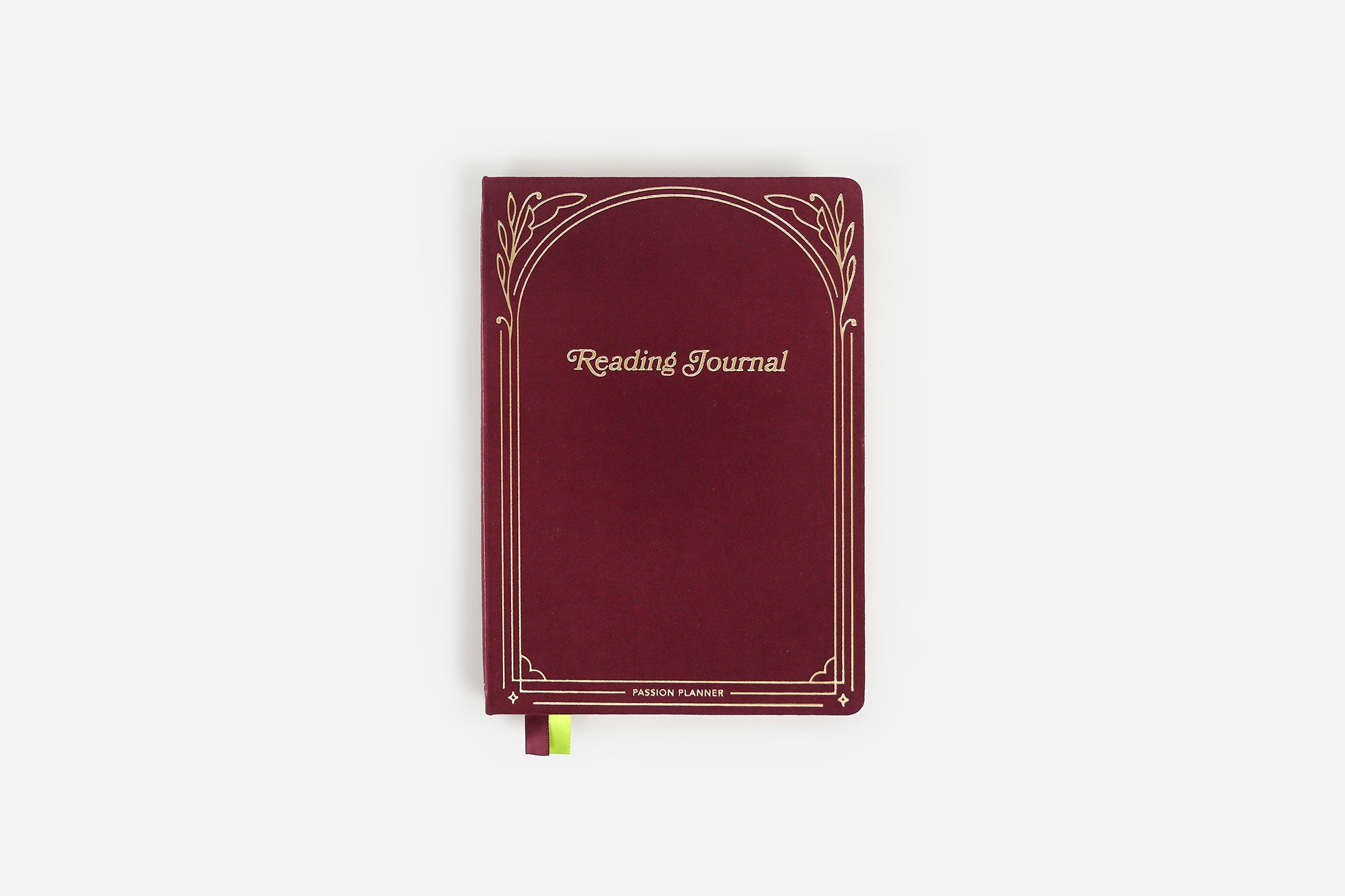 Maroon reading journal with decorative gold foil elements on a white background