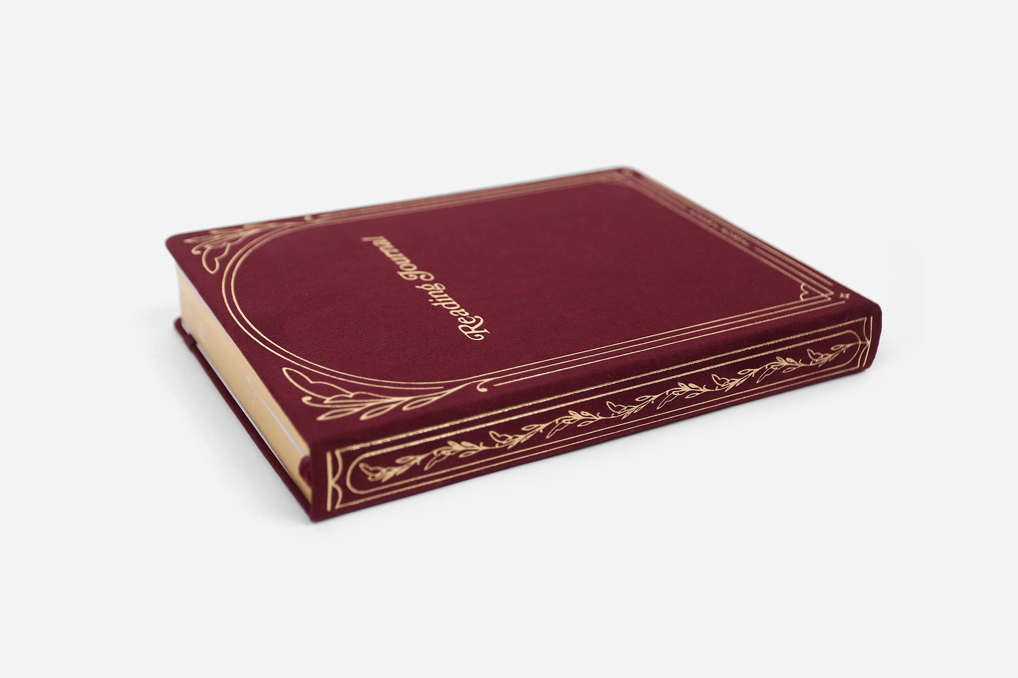 Maroon reading journal with gold foil design on a white background