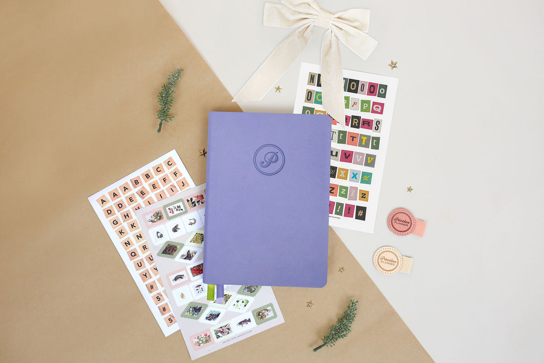 Purple journal with decorative stickers on a beige surface