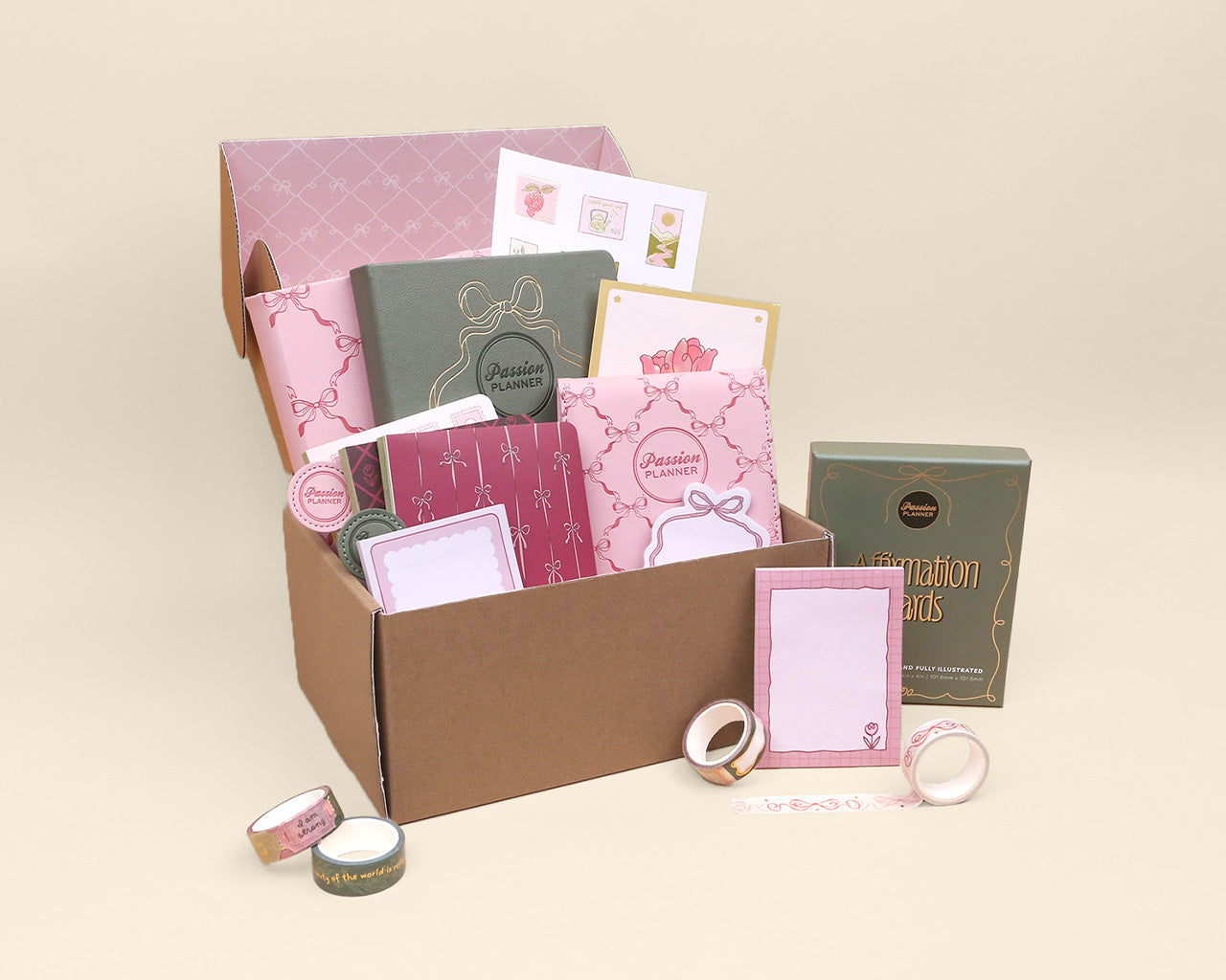 Collection of stationery items including cards and envelopes in a box on a beige background