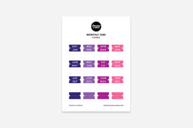 A sheet of multi-colored monthly tabs labeled with different months of the year, designed to be used in a planner.
