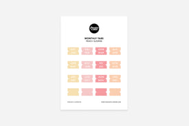 A sheet of peach pastel monthly tabs labeled with different months of the year, designed to be used in a planner.